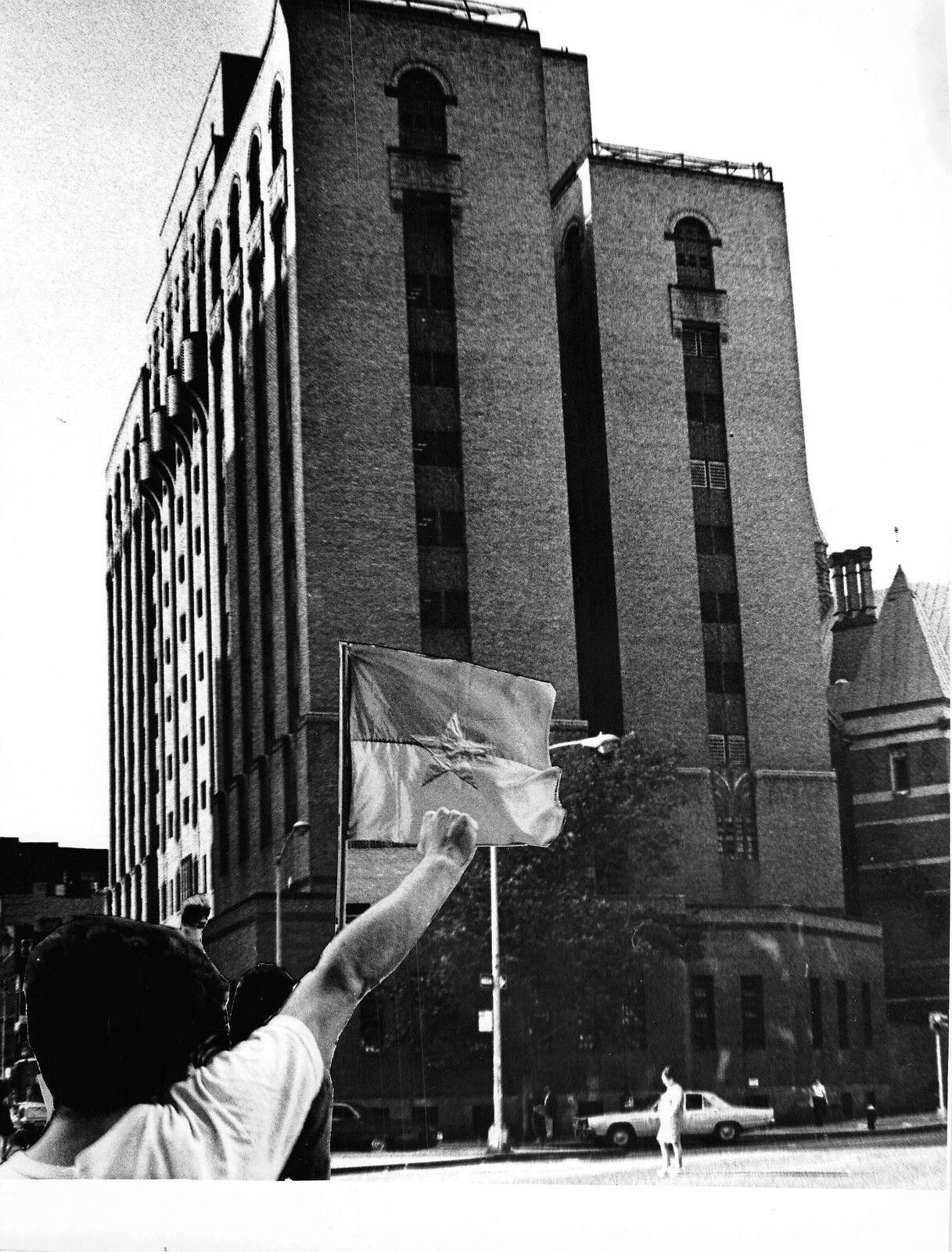 B & W Photo Man with fist in Air North Vienam flag in NYC or DC on Bastille Day 