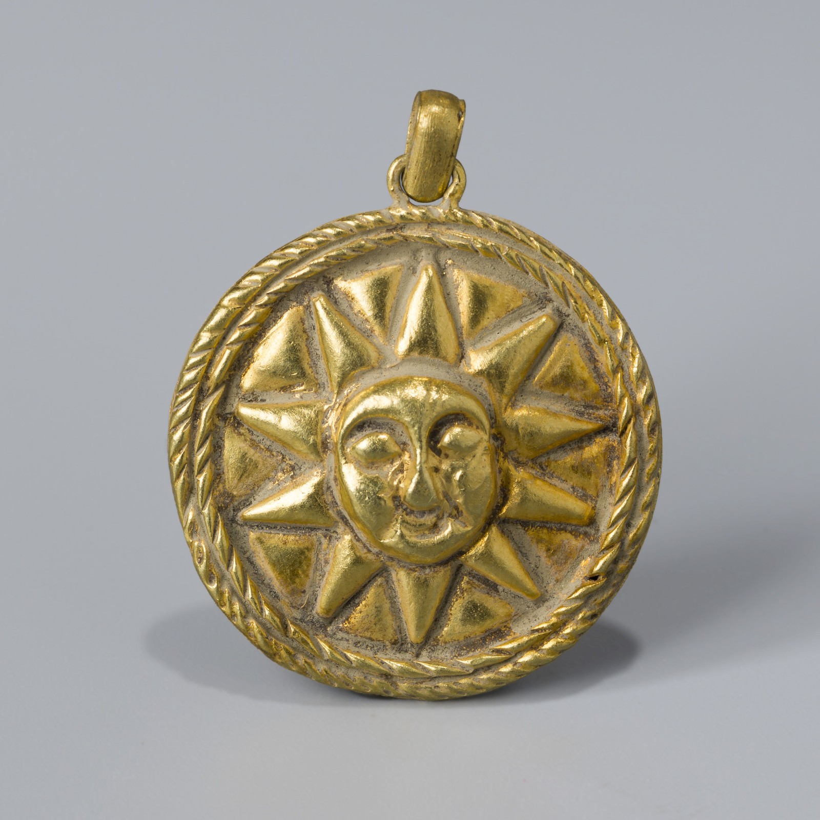 Ancient Gold Pendant with Radiant Sun and Face Motif