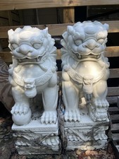 A pair of Chinese guardian lion statues made of genuine white stone. picture